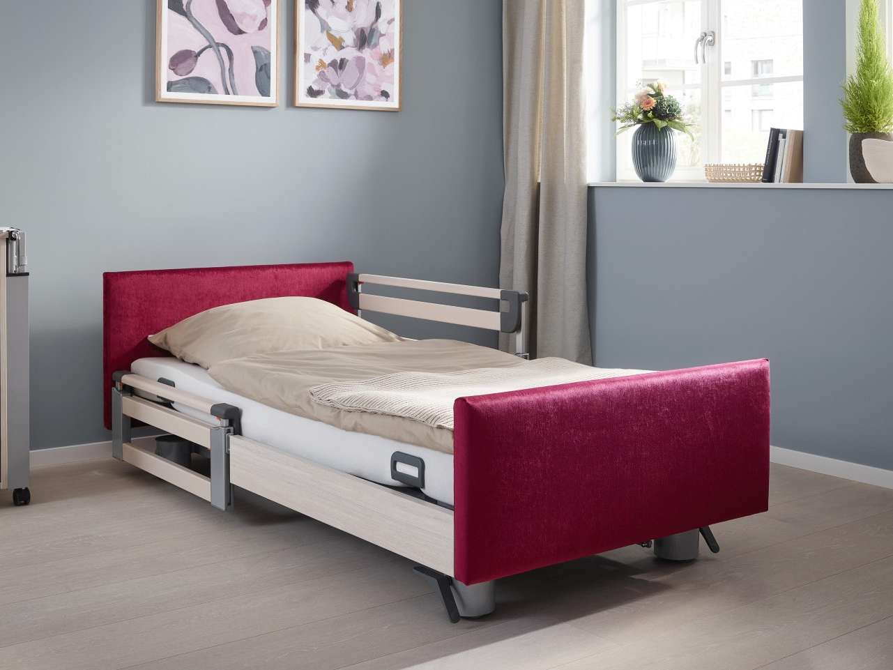 The Libra care bed from Stiegelmeyer with red fabric cover